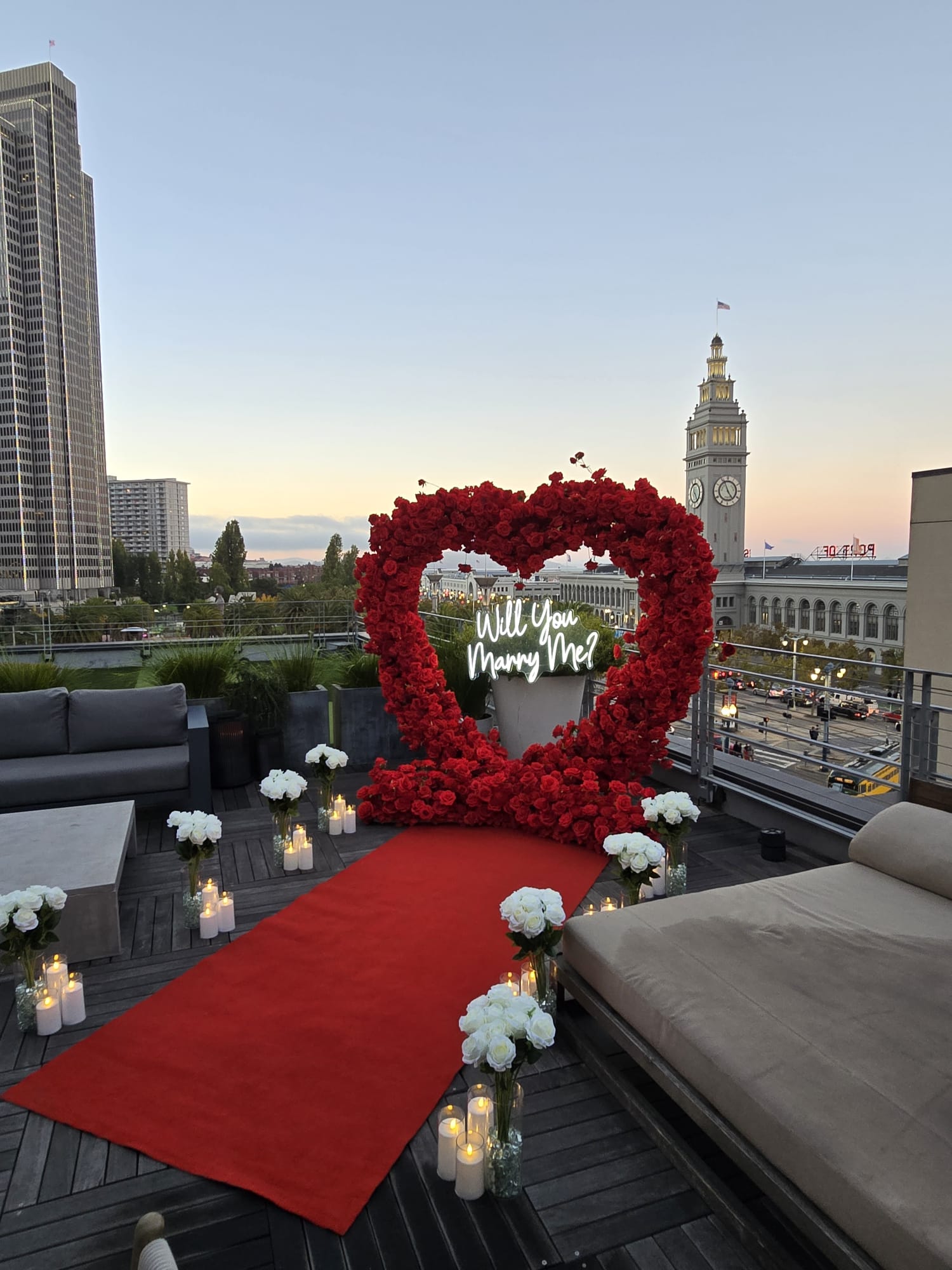 Luxury indoor proposal setup with red arch and white flowers at a San Francisco Bay Area rooftop venue
