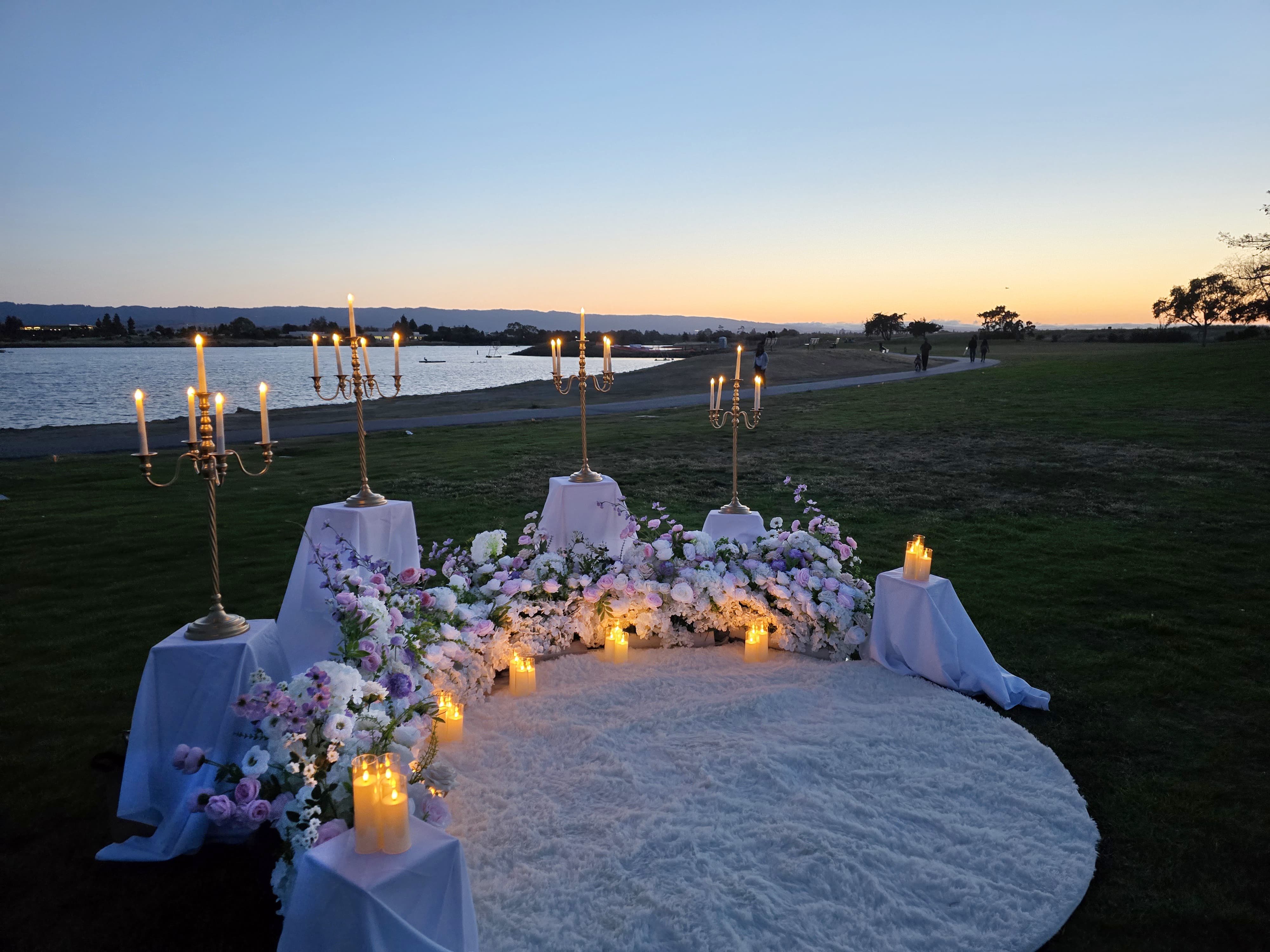 Side view of The Enchanted Romance proposal setup at Shoreline Park at twilight