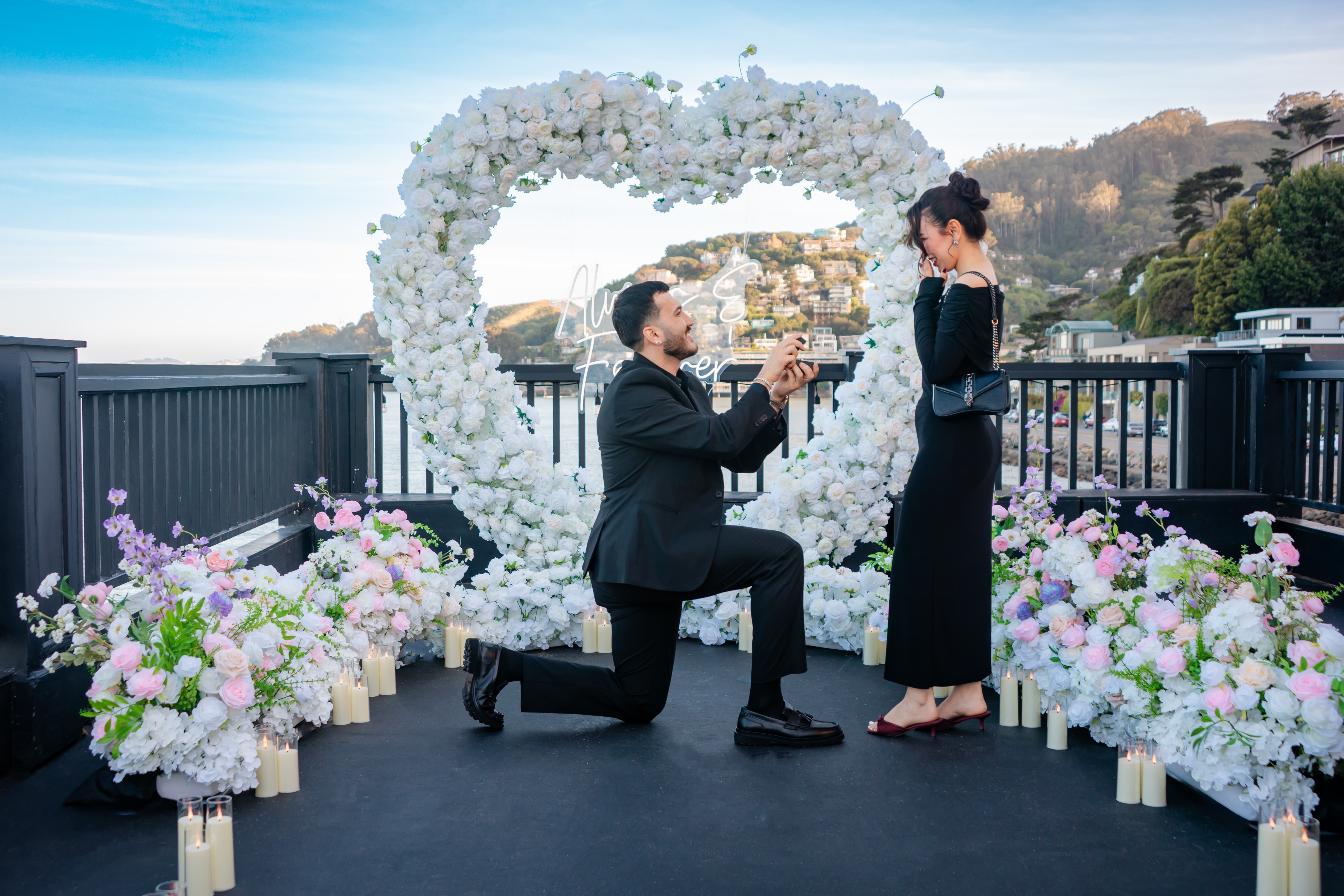 Proposal moment at ERIA Sausalito rooftop venue overlooking Richardson Bay and the San Francisco skyline