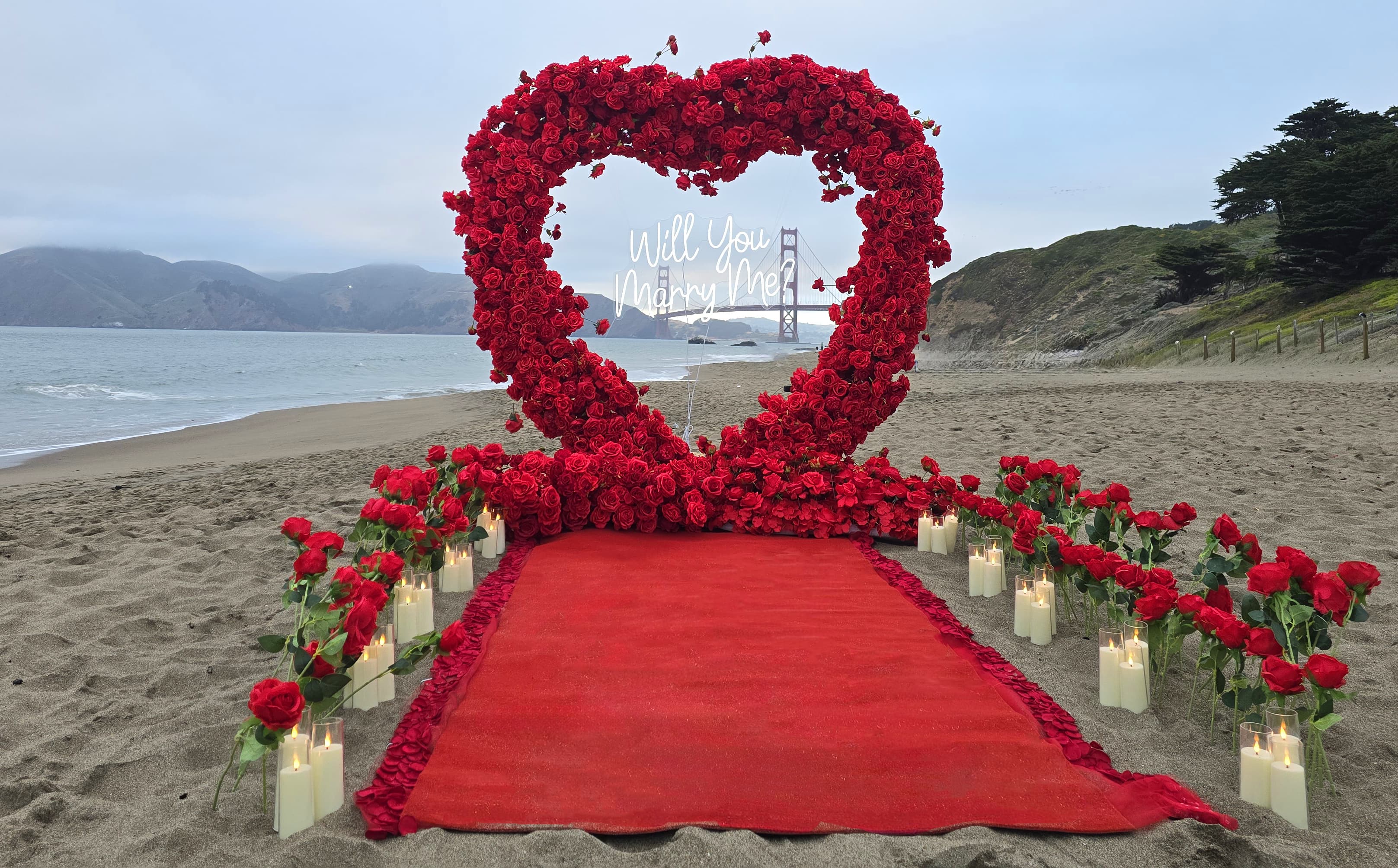 The Masterpiece Package red heart arch at Baker Beach with the Golden Gate Bridge